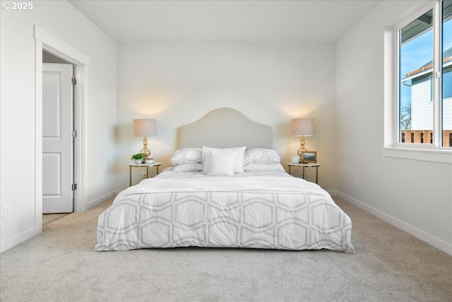 bedroom with multiple windows and light colored carpet