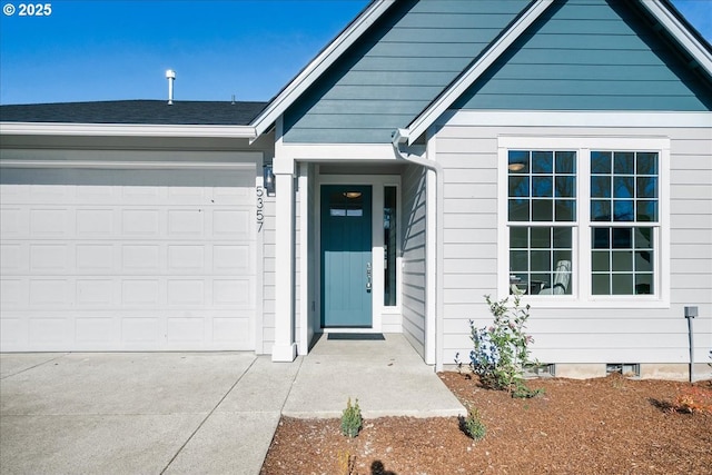 view of exterior entry with a garage