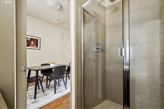 kitchen with hardwood / wood-style floors, appliances with stainless steel finishes, decorative backsplash, and sink