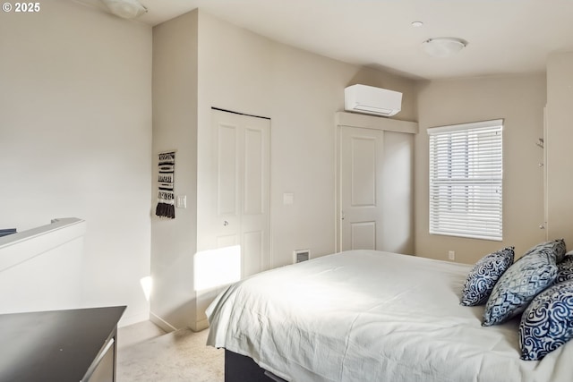 bedroom with an AC wall unit, a closet, and light carpet