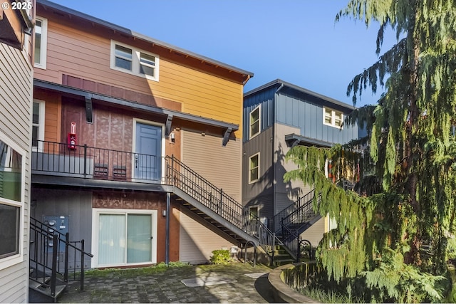 rear view of house featuring stairway and a patio