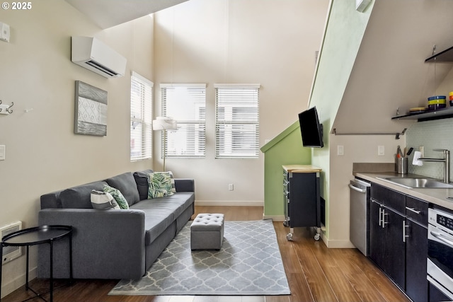 living room featuring sink, an AC wall unit, and dark wood-type flooring