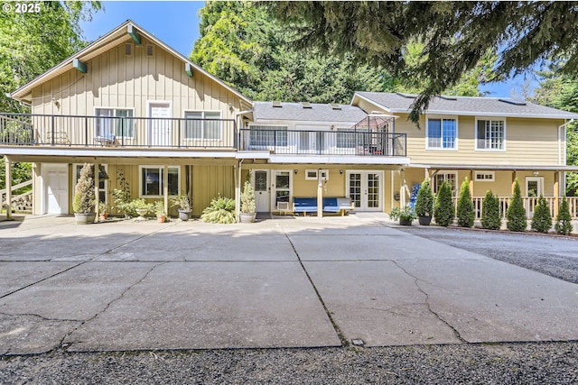 16500 SW Satterberg Rd, Beaverton, OR 97007 - view of front facade featuring board and batten siding, french doors, and a balcony