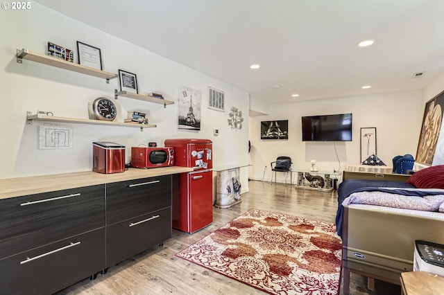 16500 SW Satterberg Rd, Beaverton, OR 97007 - kitchen with open shelves, light wood-style flooring, light countertops, recessed lighting, and dark cabinetry