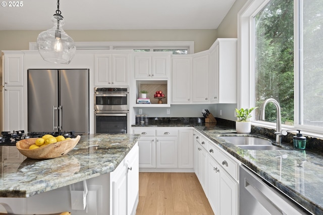 kitchen with open shelves, stainless steel appliances, white cabinets, and a sink