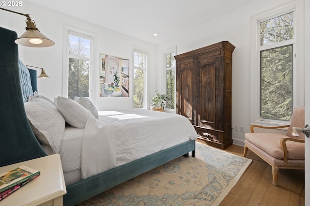 bedroom featuring hardwood / wood-style flooring and recessed lighting