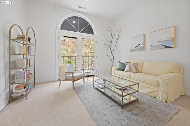 living area with carpet flooring, visible vents, and baseboards