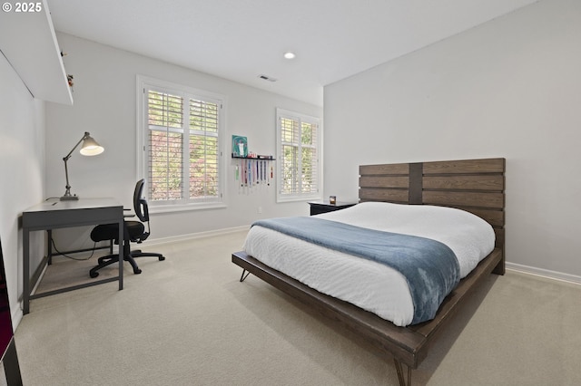 bedroom with carpet, visible vents, and baseboards