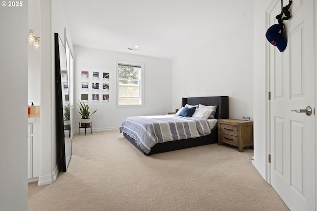 bedroom with recessed lighting, baseboards, and light carpet
