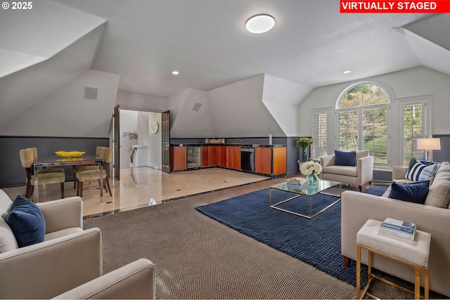 living area featuring recessed lighting, vaulted ceiling, and visible vents