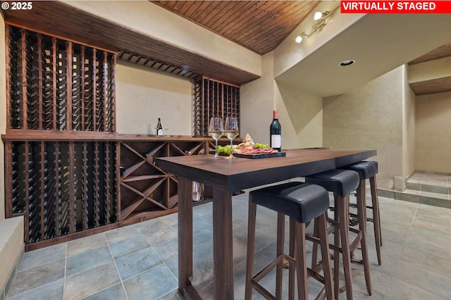 wine cellar featuring stone tile floors and wooden ceiling