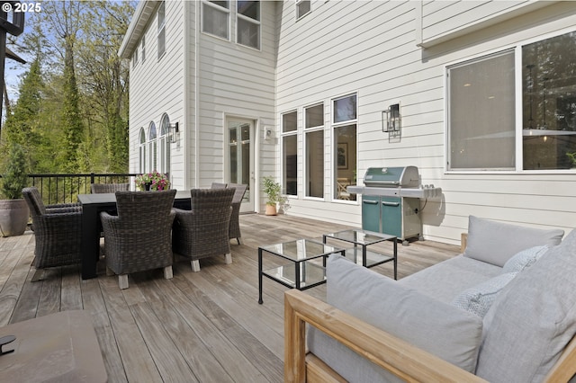 wooden terrace featuring an outdoor hangout area, outdoor dining area, and a grill