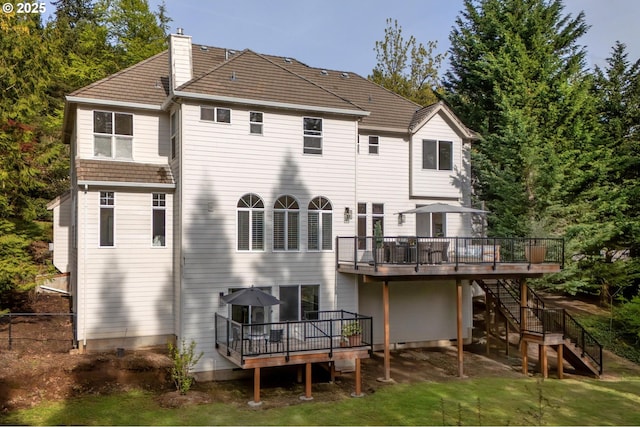 back of house featuring a chimney, a wooden deck, stairway, and fence