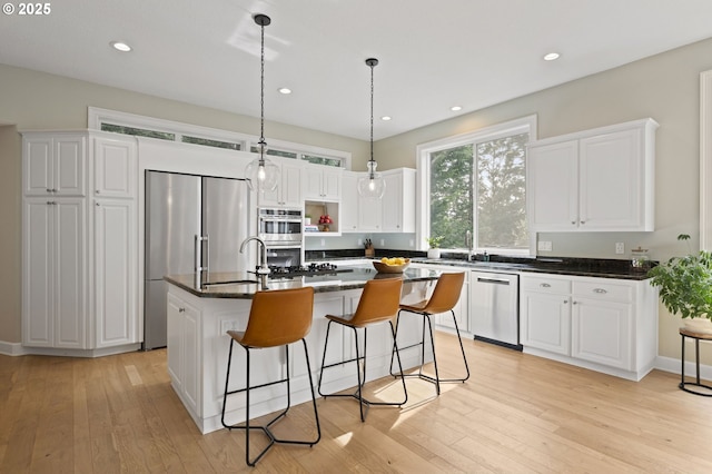 kitchen featuring light wood-style flooring, white cabinetry, and stainless steel appliances