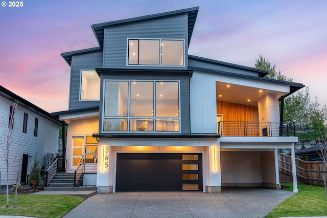 565 W U St, Washougal, WA 98671 - view of front of property with concrete driveway, fence, a balcony, and a garage