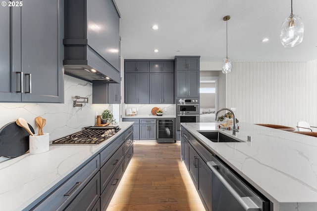 565 W U St, Washougal, WA 98671 - kitchen with a sink, custom exhaust hood, beverage cooler, light wood-style floors, and stainless steel appliances