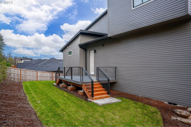 565 W U St, Washougal, WA 98671 - rear view of property featuring a lawn, fence, and a wooden deck