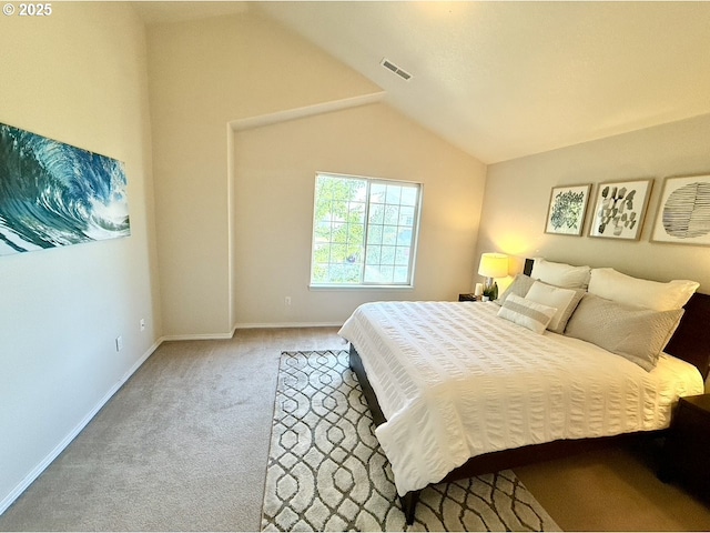 carpeted bedroom with lofted ceiling