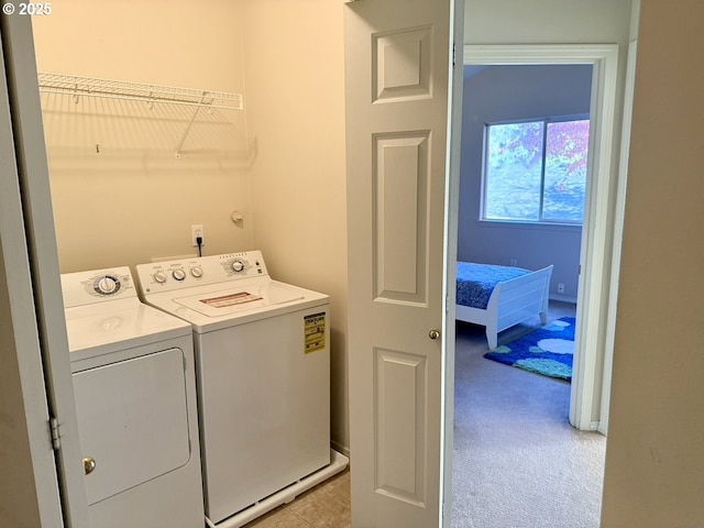 clothes washing area featuring light carpet and independent washer and dryer