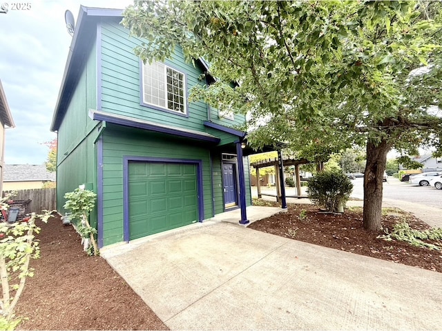 view of side of property with a pergola and a garage