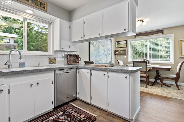 6985 SW Florence Ln, Portland, OR 97223 - kitchen with dishwasher, wood finished floors, plenty of natural light, and backsplash