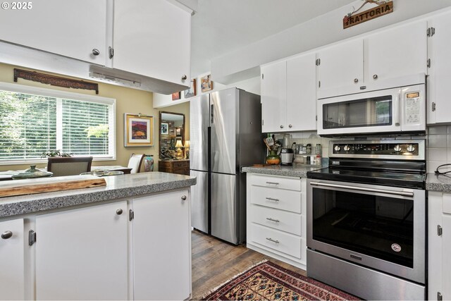 6985 SW Florence Ln, Portland, OR 97223 - kitchen featuring appliances with stainless steel finishes, white cabinets, backsplash, wood finished floors, and light countertops