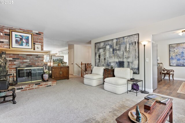 6985 SW Florence Ln, Portland, OR 97223 - carpeted living room featuring a fireplace and baseboards
