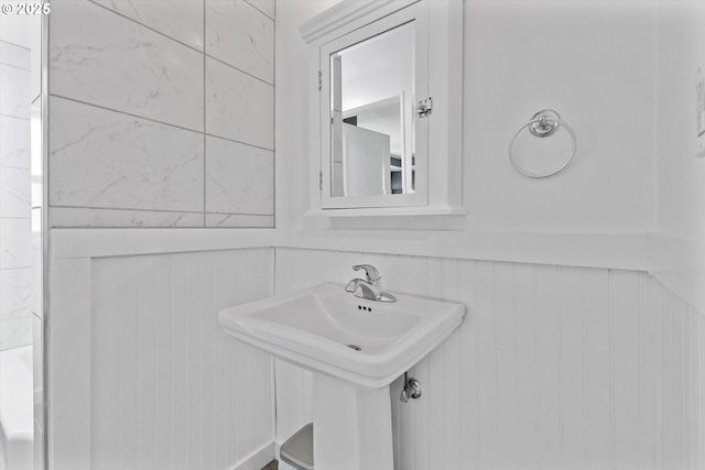 6815 N Smith St, Portland, OR 97203 - bathroom with wainscoting, a sink, and a decorative wall