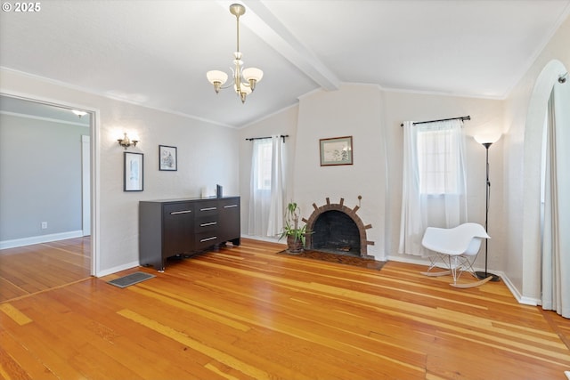 6815 N Smith St, Portland, OR 97203 - living area with light wood-type flooring, a fireplace, a chandelier, baseboards, and ornamental molding