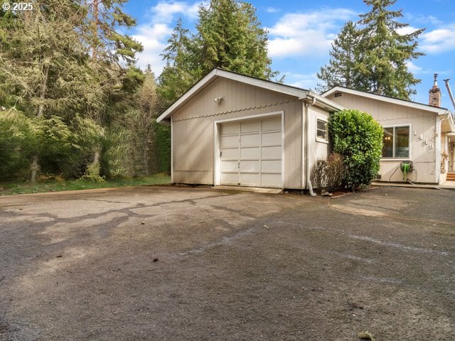 garage with aphalt driveway