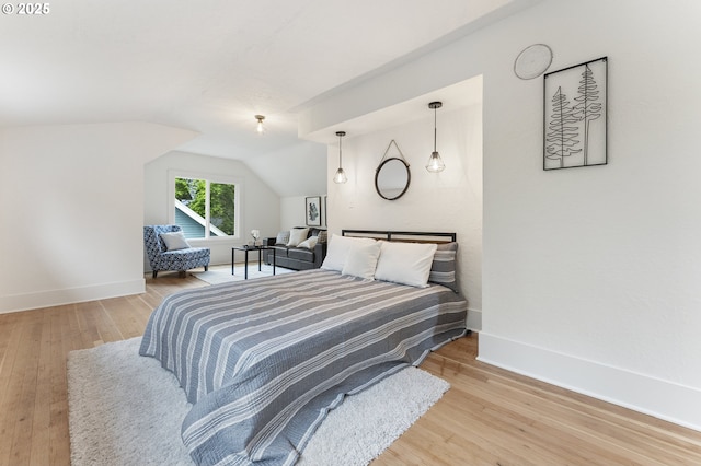 6516 SE 17th Ave, Portland, OR 97202 - bedroom with wood finished floors, vaulted ceiling, and baseboards