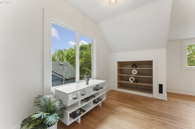6516 SE 17th Ave, Portland, OR 97202 - additional living space with vaulted ceiling, light wood-style flooring, built in features, and baseboards