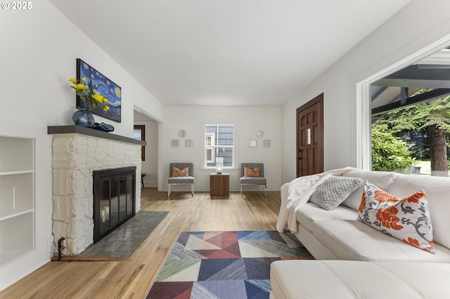 6516 SE 17th Ave, Portland, OR 97202 - living room featuring a stone fireplace and light wood-style flooring
