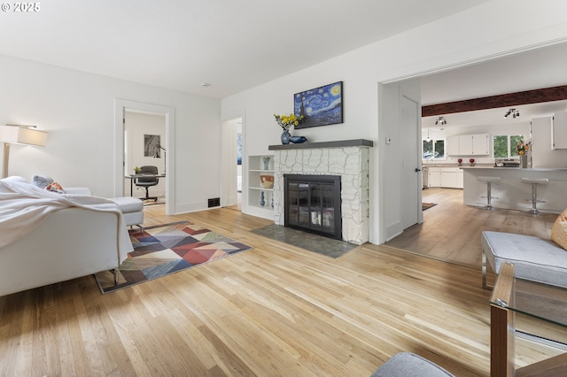 6516 SE 17th Ave, Portland, OR 97202 - living area with light wood finished floors, a fireplace, and baseboards
