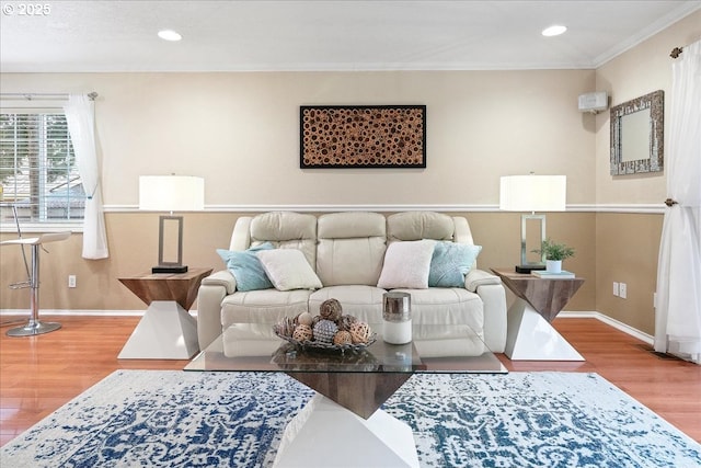 living area with ornamental molding, recessed lighting, baseboards, and wood finished floors