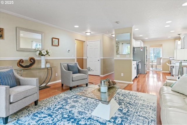 living room featuring light wood finished floors, baseboards, and crown molding