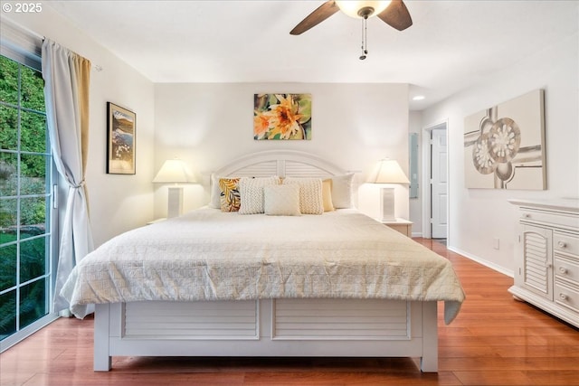 bedroom featuring access to exterior, ceiling fan, baseboards, and wood finished floors