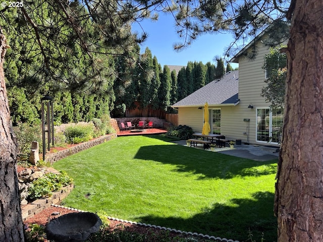 view of yard featuring a patio and fence