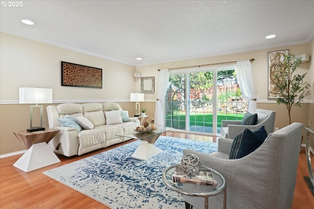 living room featuring crown molding, a textured ceiling, wood finished floors, and recessed lighting