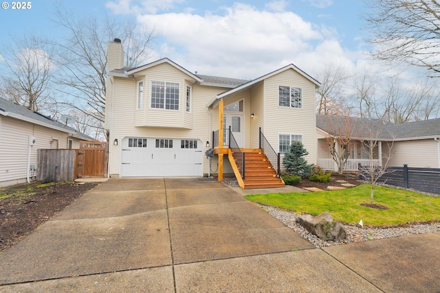 view of front of house with a chimney, fence, driveway, and an attached garage