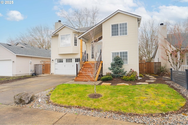 split foyer home with a garage, concrete driveway, a chimney, and fence