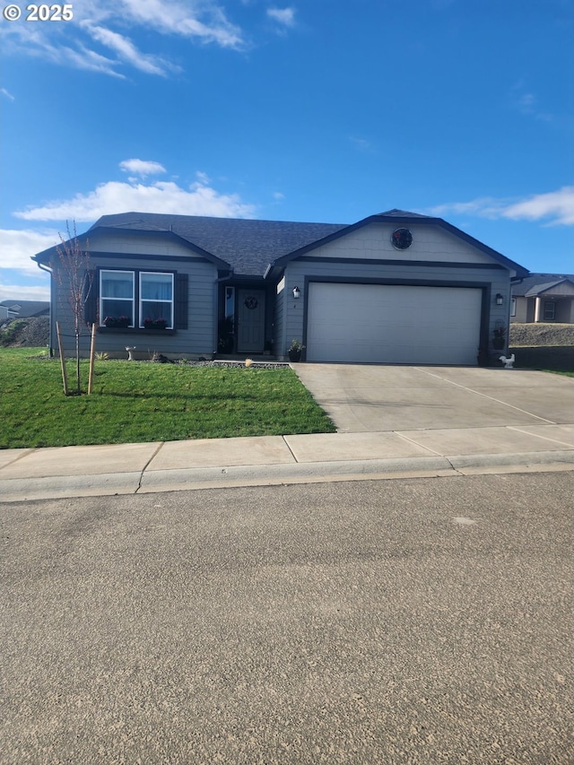 ranch-style house featuring a garage, concrete driveway, and a front yard