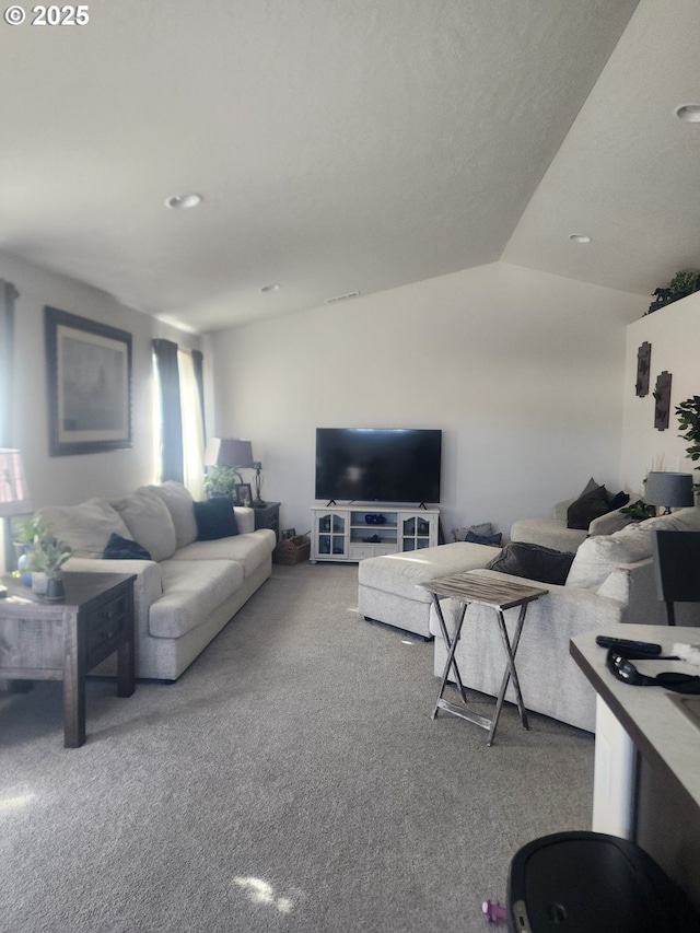 living area featuring carpet and vaulted ceiling