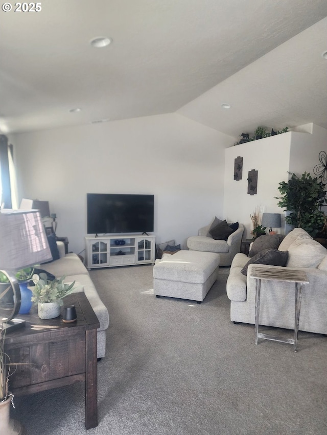 carpeted living area featuring lofted ceiling