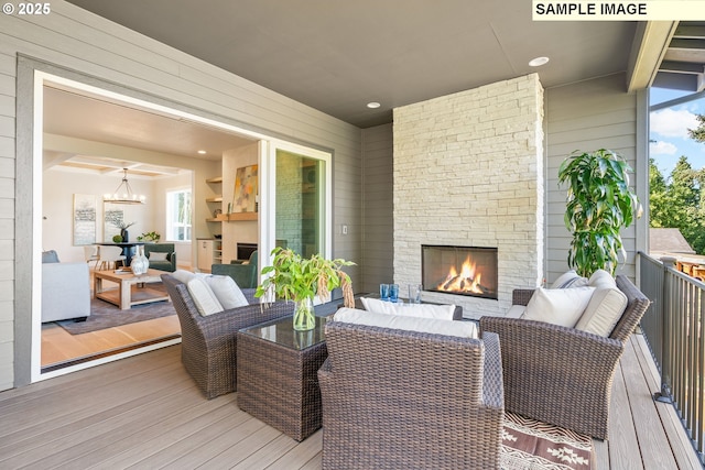 wooden deck with an outdoor living space with a fireplace