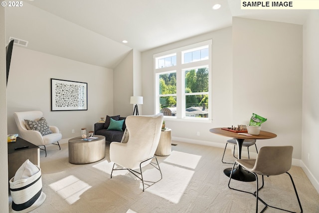 living area with lofted ceiling, baseboards, visible vents, and recessed lighting