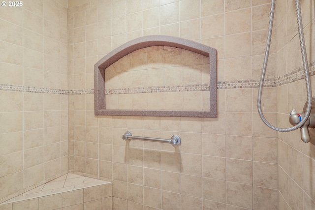 bathroom with a tile shower