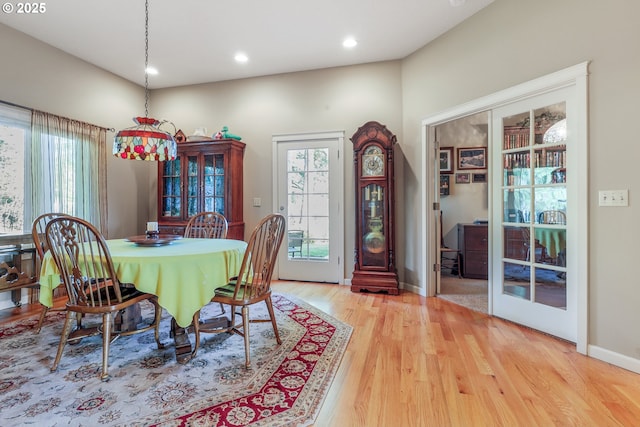 dining area with french doors and light hardwood / wood-style flooring