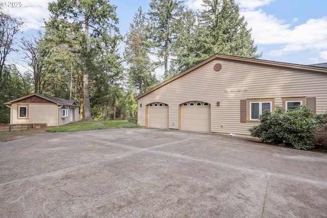 view of home's exterior featuring an outbuilding and a garage