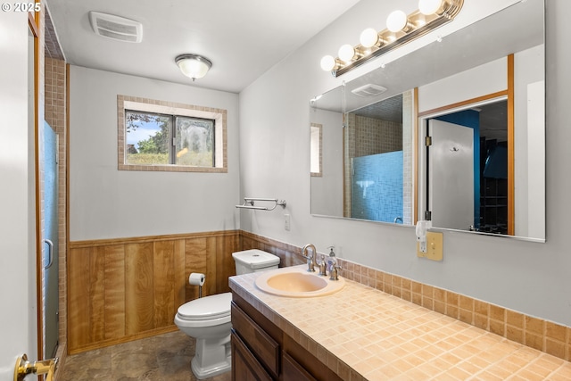 32505 Viewcrest Dr, Warren, OR 97053 - bathroom with wainscoting, toilet, vanity, an enclosed shower, and wood walls